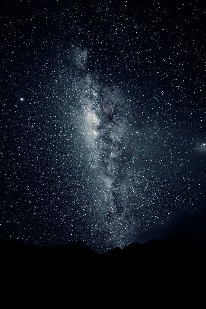 Captivating view of the Milky Way galaxy with a mountain silhouette under a starry night sky.
